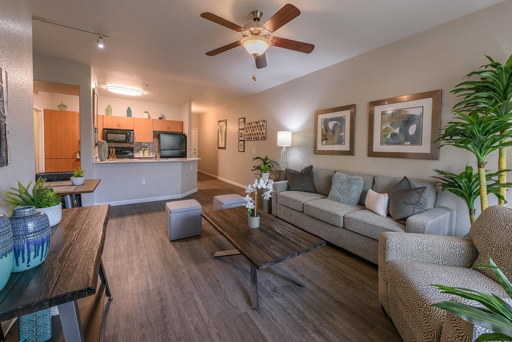 a living room with a ceiling fan and a couch
