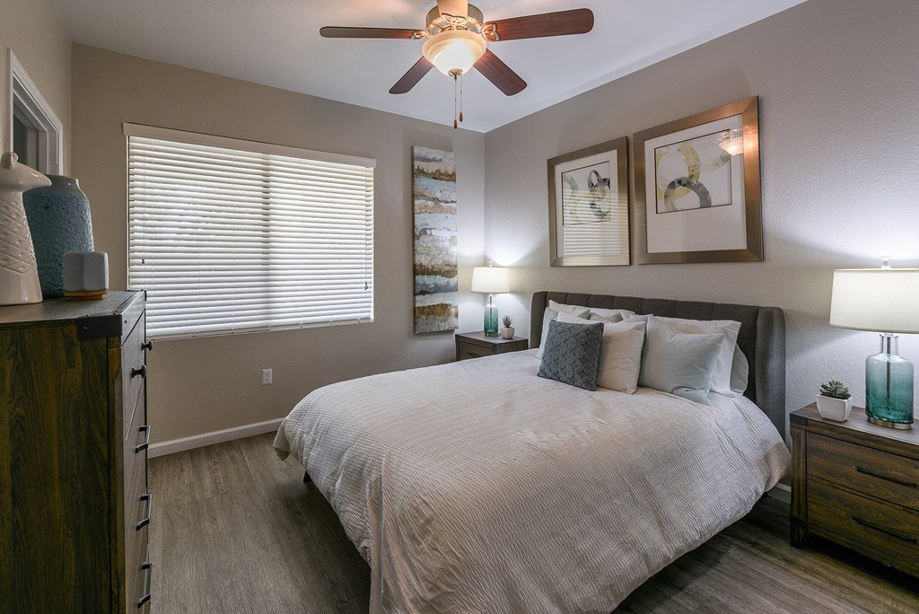 a bedroom with a large bed and a ceiling fan