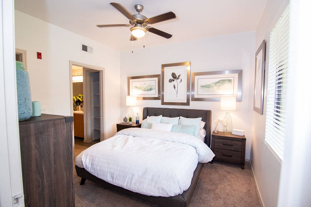 a bedroom with a large bed and a ceiling fan