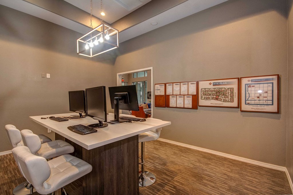 a home office with two computer monitors on a desk