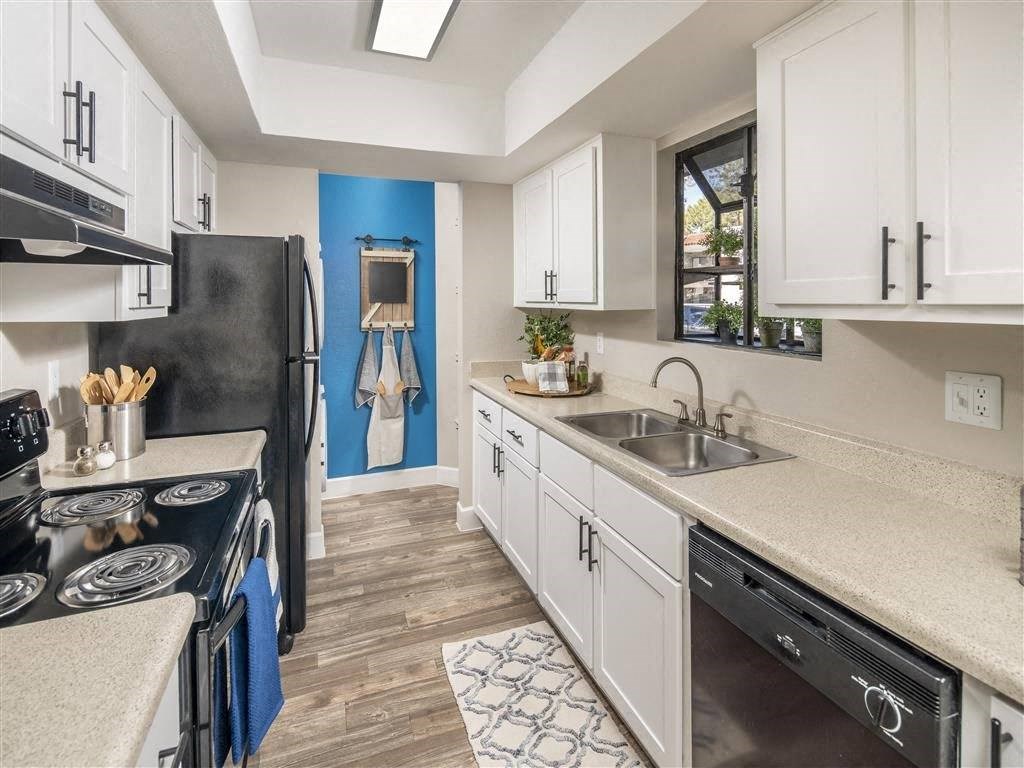 a kitchen with a sink and a stove and a refrigerator
