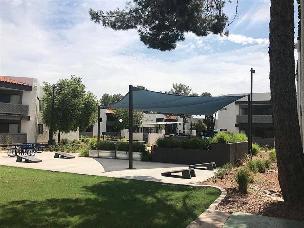 a park with benches and a canopy