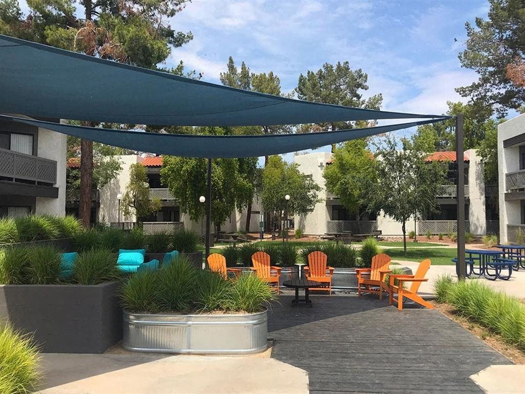 a patio with chairs and a canopy