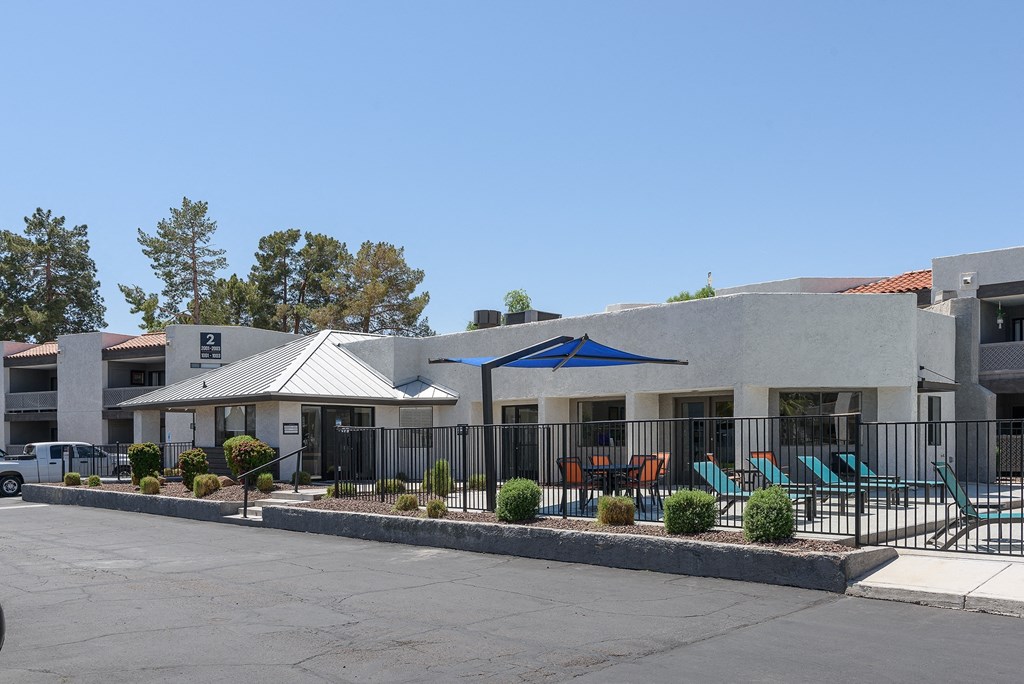 an exterior view of a building with tables and chairs in front of it