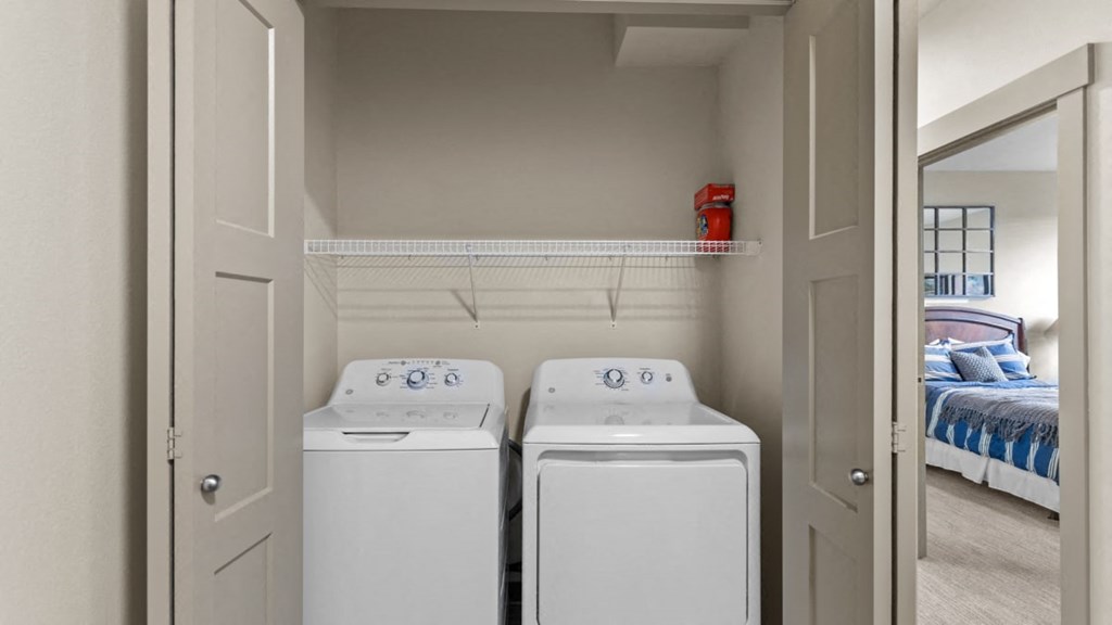 A small laundry room with a washer and dryer.