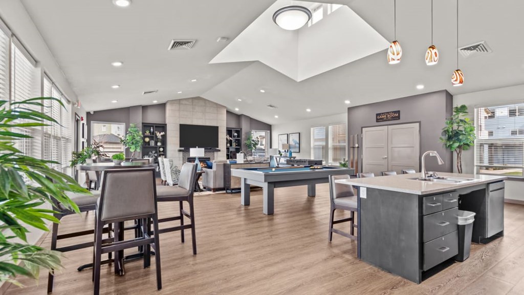 A modern office space with wooden floors and grey furniture.