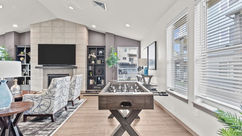 A modern living room with a fireplace and a television.