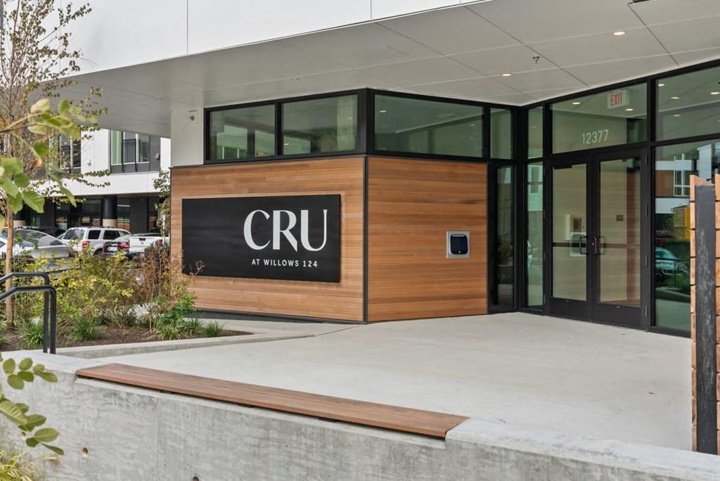 The front of a building with the letters CRU on it at Cru at Willows Apartments, Redmond, 98052