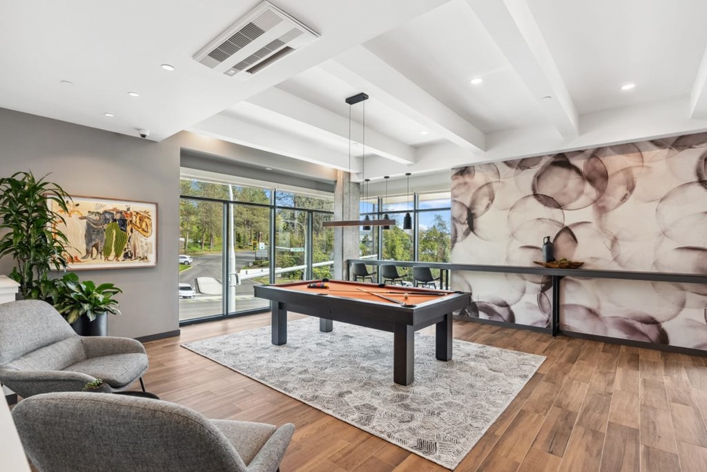 A room with a pool table and a large painting on the wall at Cru at Willows Apartments, Redmond, WA