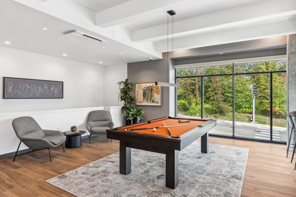 A room with a pool table and chairs. A room with a pool table and chairs at Cru at Willows Apartments, Redmond, Washington, 98052