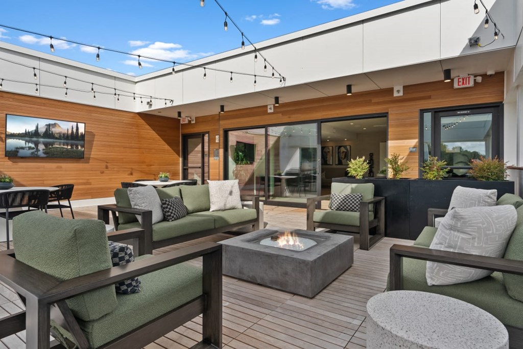 A patio with a fire pit and seating area at Cru at Willows Apartments, Redmond, Washington