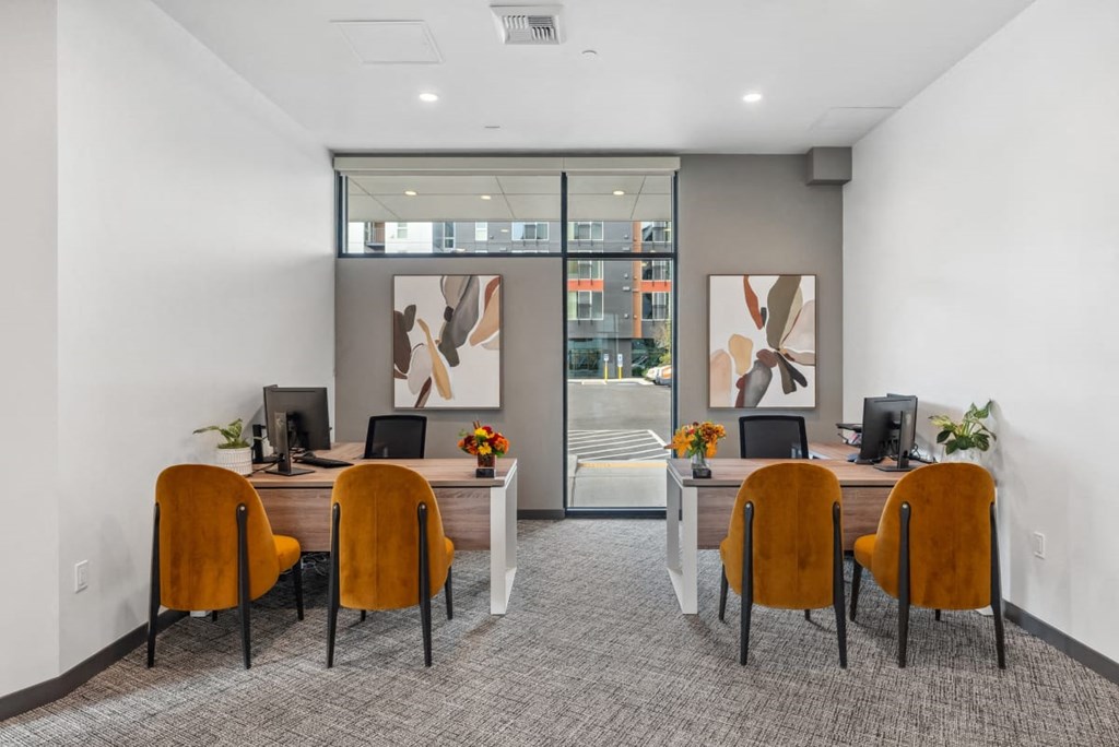 A room with a desk and chairs with a painting on the wall at Cru at Willows Apartments, Redmond