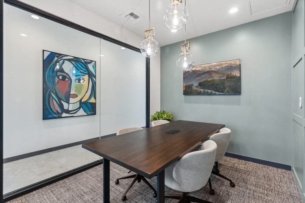 A conference room with a wooden table and chairs at Cru at Willows Apartments, Redmond, WA
