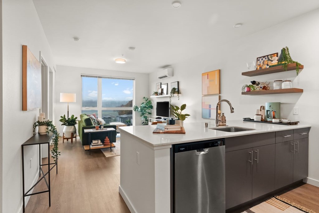 A modern kitchen with a large island and stainless steel appliances. A modern kitchen with a large island and stainless steel appliances at Cru at Willows Apartments, Redmond