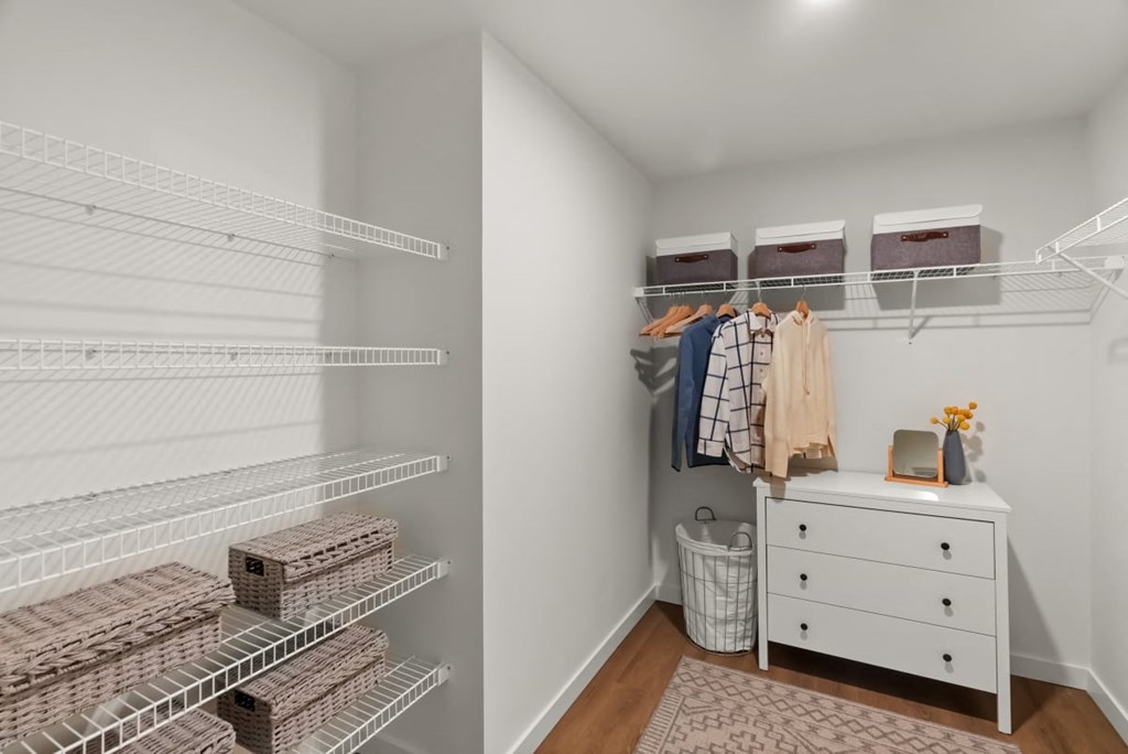 A white closet with a white dresser and a white rug at Cru at Willows Apartments, Redmond, Washington, 98052