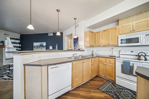 A kitchen with wooden cabinets and white appliances.