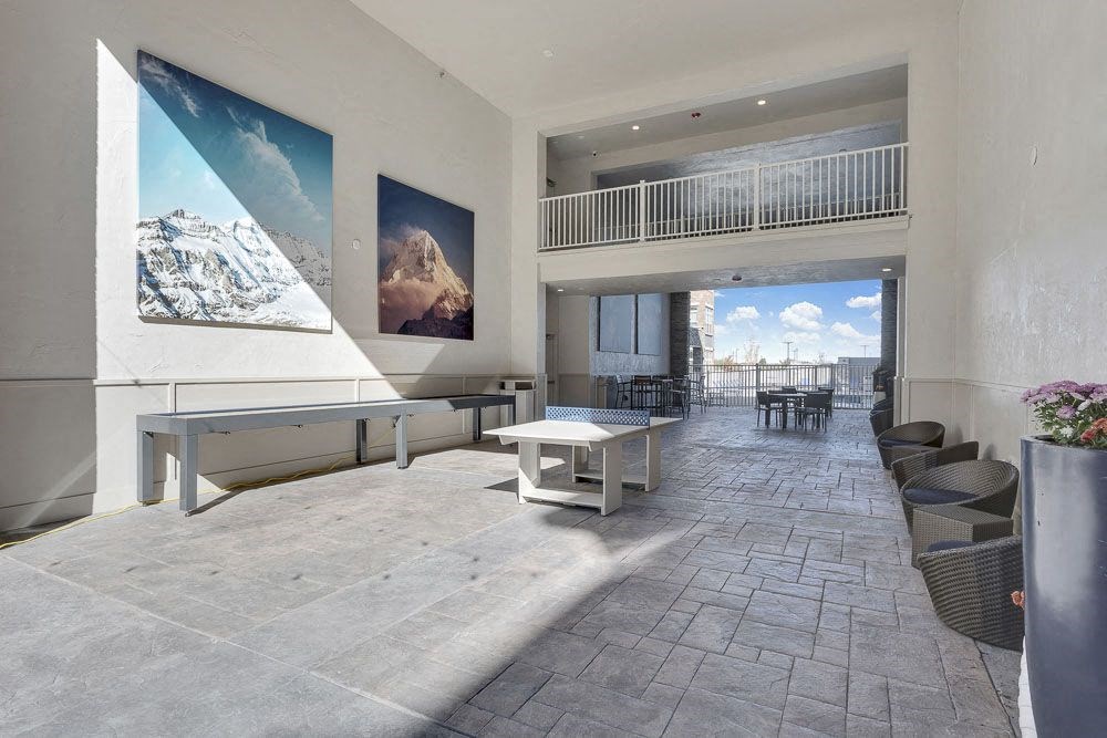A spacious patio with a table and chairs.