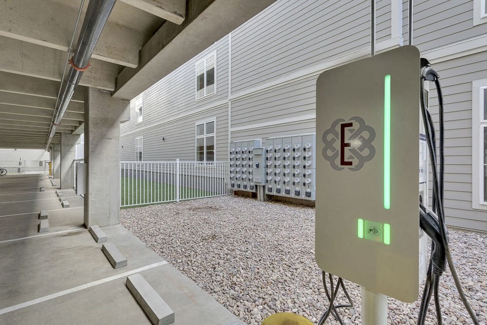 A parking garage with a charging station for electric vehicles.