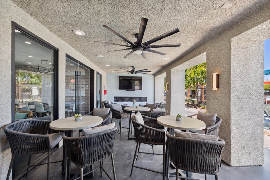 Colton Apartments A patio with a table and chairs and a ceiling fan.