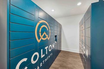 A hallway with blue walls and the words "Colton Apartments" written on them.