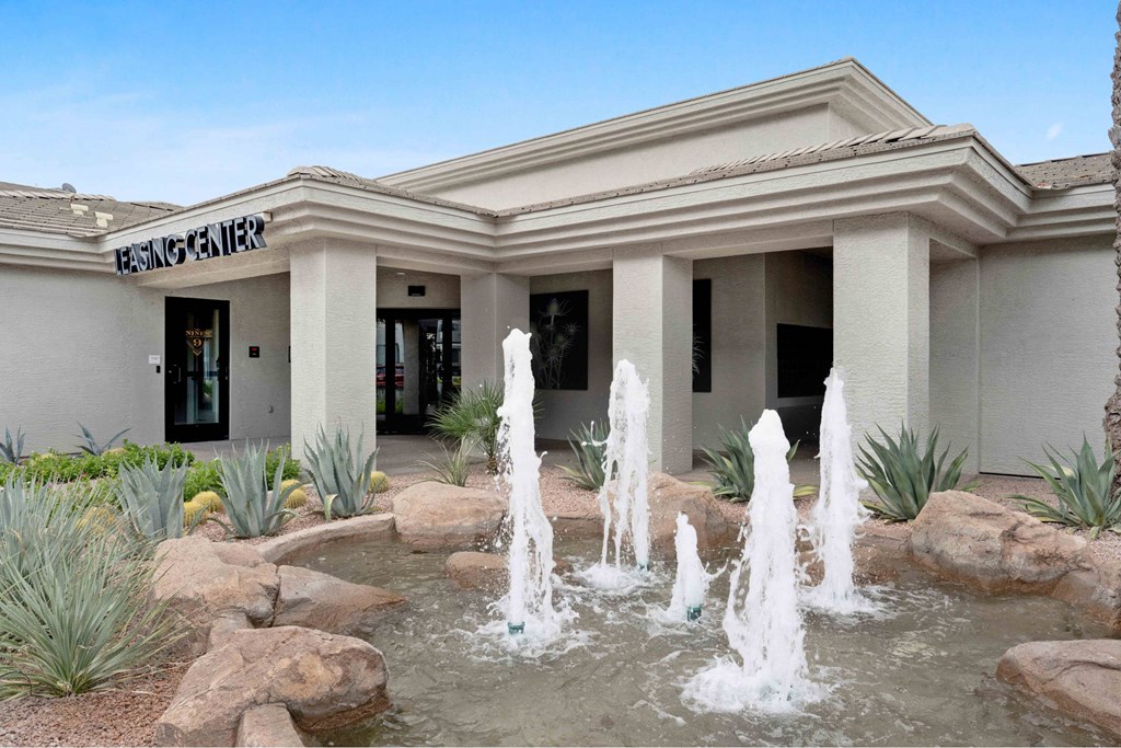 A building with a fountain in front of it.