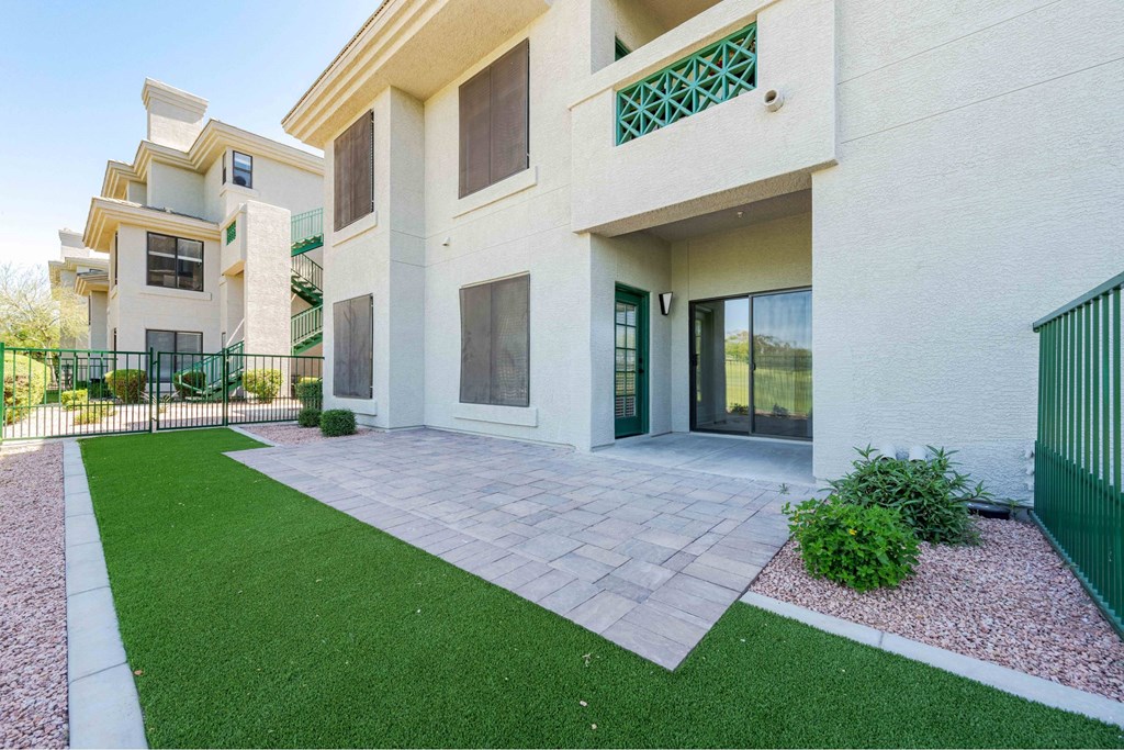 A modern house with a green lawn in front.