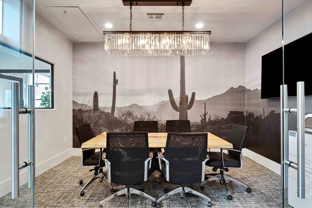 A conference room with a desert mural on the wall.
