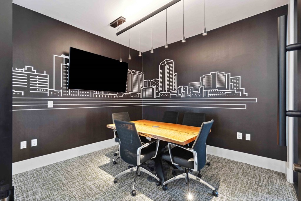 A conference room with a city skyline mural on the wall.