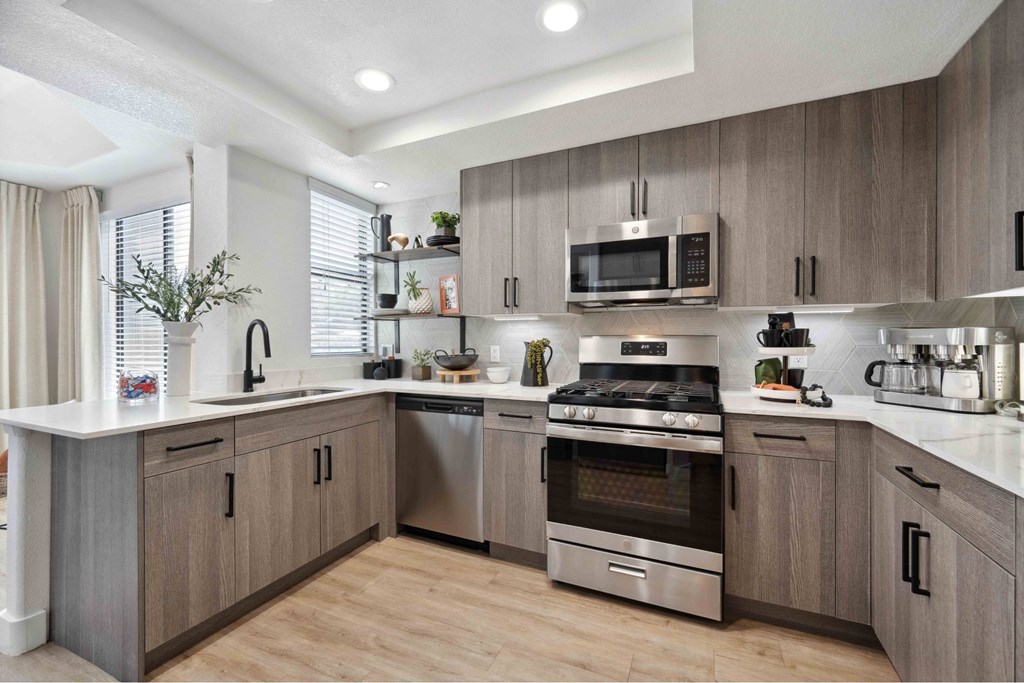 A modern kitchen with wooden cabinets and stainless steel appliances.