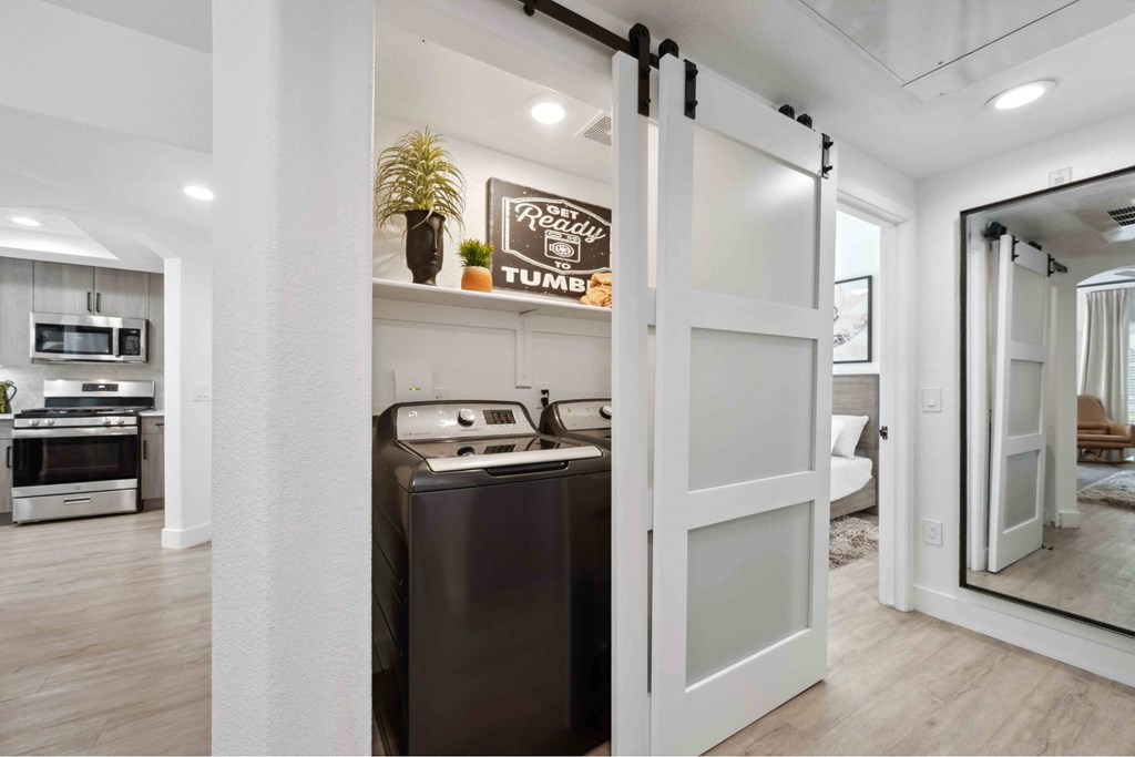 A modern kitchen with a white fridge and a white door.