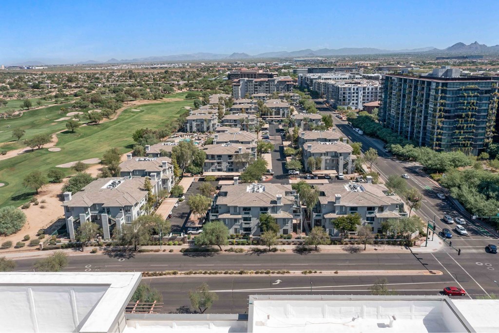A view of a residential area with apartment buildings and a golf course.