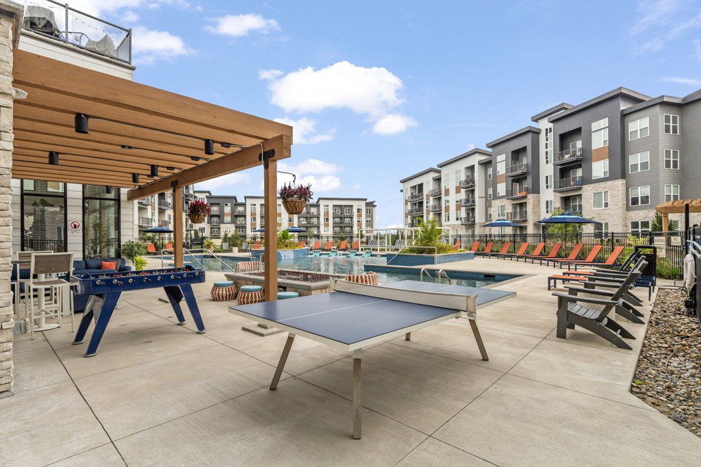 furnished patio with ping pong tables and amenities at the addison at collin