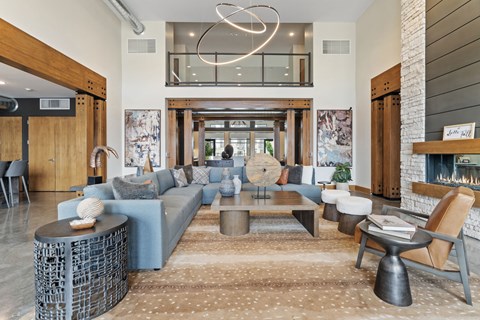 A modern living room with a blue sofa and a wooden coffee table.