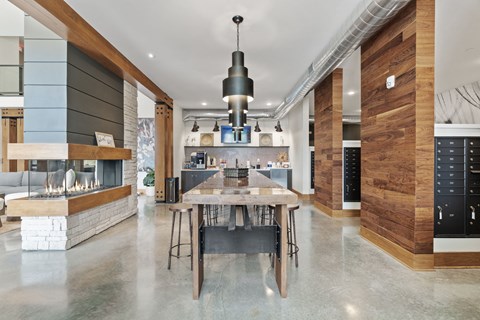 A modern kitchen with a dining table and chairs in the middle of the room.