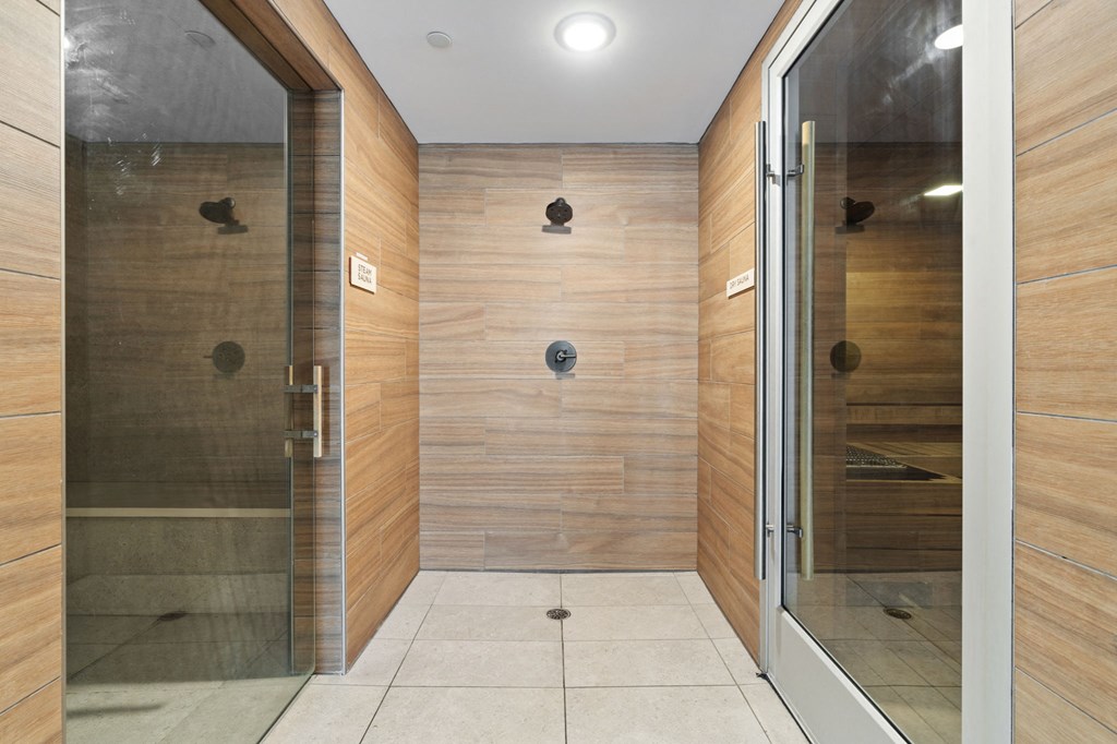 a large bathroom with a large shower and a glass door