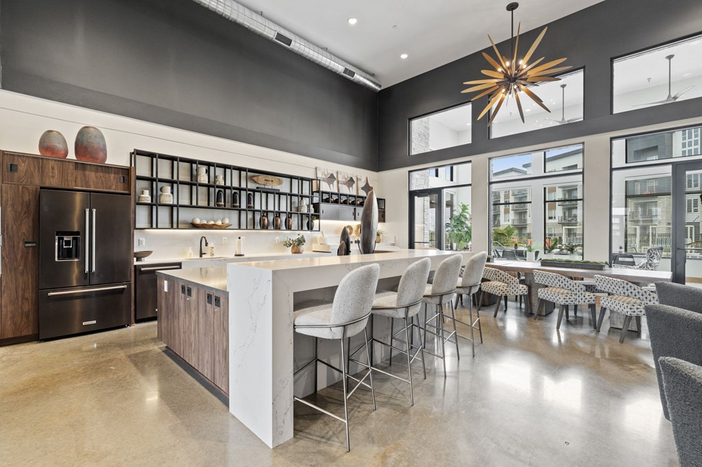 A modern kitchen with a large island and bar stools.