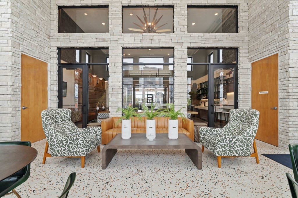 A room with a brick wall and a fireplace with a glass door.