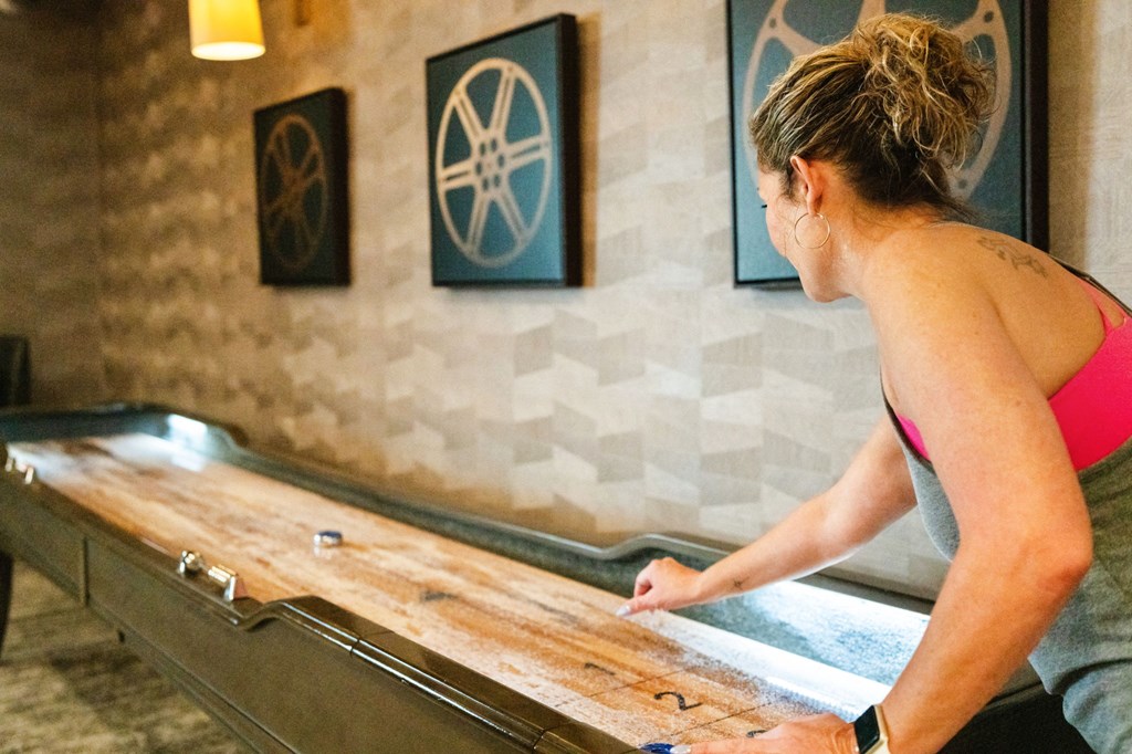 a woman sitting on a staircase looking at a reflection in a mirror on the floor