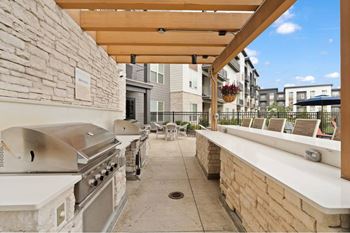 the preserve at ballantyne commons spacious outdoor kitchen with grill and seating area