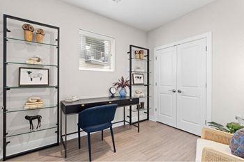 a home office with a desk and a door