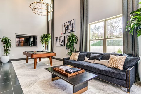 A living room with a pool table and a couch.