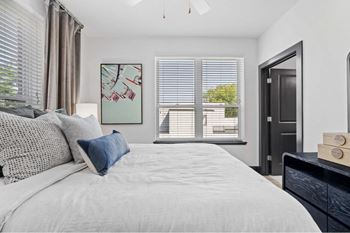 a bedroom with a large bed and a window