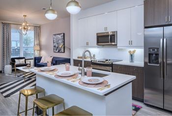 a kitchen with a center island with plates on it