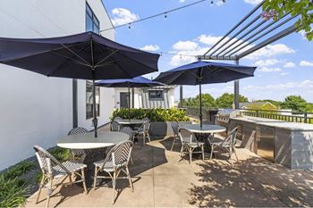 a patio with tables and umbrellas on a roof