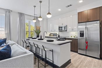 a kitchen with a large island and a refrigerator