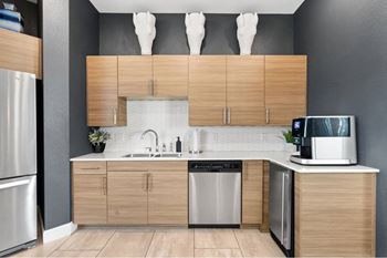 a modern kitchen with wooden cabinets and stainless steel appliances
