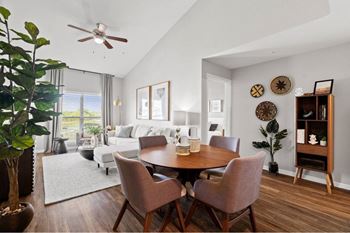 a living room with a dining room table and a couch