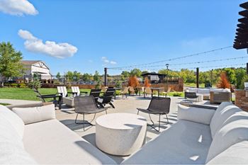 a patio with couches and chairs and tables