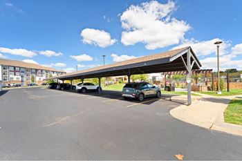 a parking lot with cars parked under a canopy