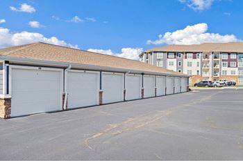 a row of garage doors in front of an apartment building